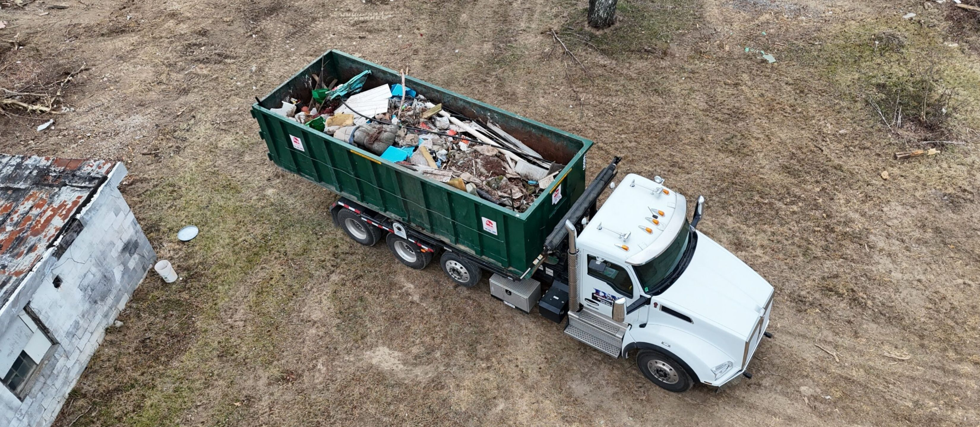 Roll off dumpster filled with construction debris on a hauling truck in Winchester VA